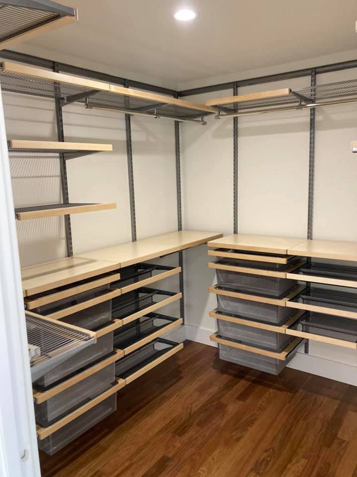 Custom walk-in pantry with adjustable shelving, pull-out storage bins, and modern organization system.